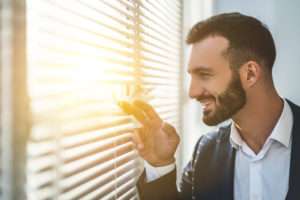 man-enjoying-sunshine-in-window